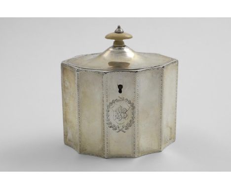 A GEORGE III TEA CADDY with vertically fluted panels around the sides, border engraving and a domed cover with an ivory finia