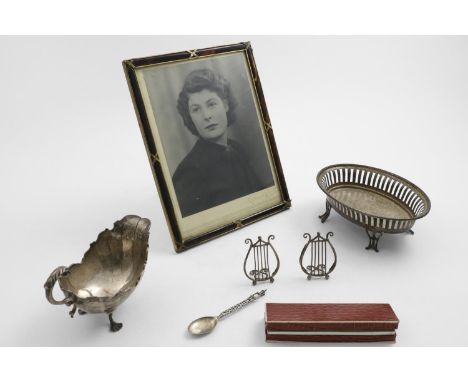 A MIXED LOT:- An Edwardian oval bonbon dish, a small sauce boat, a mounted cheroot holder, a small spoon, a pair of late Vict
