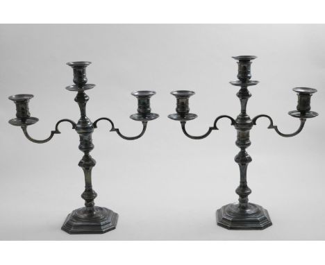 A PAIR OF ELIZABETH II THREE-LIGHT CANDELABRA on canted square bases with "well" centres, knopped &amp; shouldered columns an