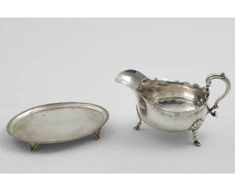 A GEORGE III OVAL TEA POT STAND on bracket feet with bead borders, by Elizabeth Jones, London 1787 and a late Victorian sauce