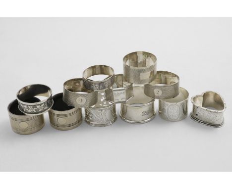 NAPKIN RINGS:- An engraved, heart-shaped example, an Edwardian pierced example with a heart-shaped cartouche, a pair of engin