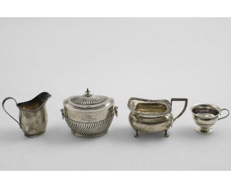 AN EDWARDIAN PART-FLUTED OVAL TEA CADDY with drop-ring handles and a crest &amp; motto in relief on the front, by J.B. Carrin