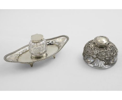 A LATE VICTORIAN MOUNTED GLASS CIRCULAR INKWELL with an embossed mantle and a start-cut base, by William Comyns, London 1894,