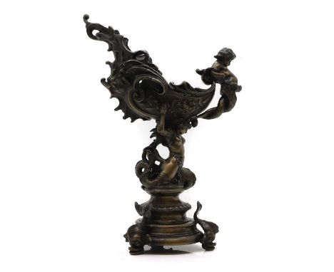 A Renaissance revival patinated bronze alloy ewer, in the form of a nautilus cup, raised on dolphin feet, signed 'GILEN',51cm