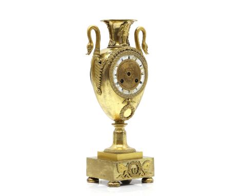 A French Empire ormolu cased mantle clock the case with Swan handles and urn finial on square plinth base and ball feet 18cm 