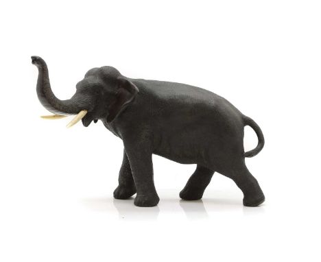 A Japanese bronze elephant  Meiji period, standing with its head inclined and trunk up, with ivory tusks,  27cm long  IMPORTA