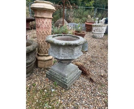 A gothic style stone font, 20th century, the octagonal top over quatrefoil decorated body and raised on a flared square socle