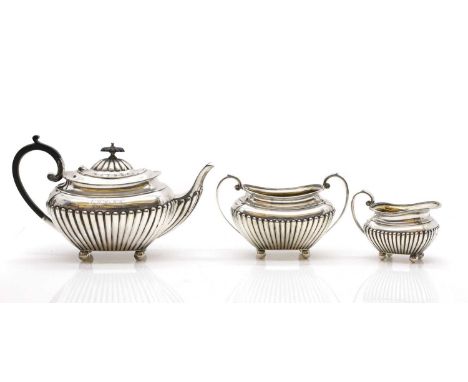 A silver three piece bachelor’s tea service, by James Dixon &amp; Son, Sheffield 1924, comprising a teapot, 25cm wide, twin-h