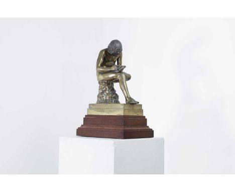 After the Antique 20th century, a Grand Tour gilt-bronze figure of the Spinario, raised on a stepped wooden base, 27cm wide20