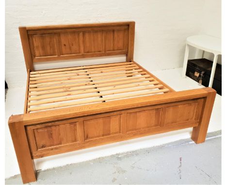 LIGHT OAK KING SIZE BEDwith a panelled head and footboard and slatted base, 194cm wide 