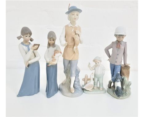 NAO FIGURINEof a young boy by a tree stump with his dog, 23cm high, two Casades figurines of a young girl holding a dog, the 