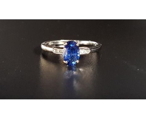 SAPPHIRE AND DIAMOND RINGthe central oval cut sapphire weighing approximately 0.95cts flanked by three small diamonds to each