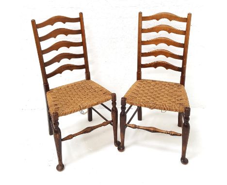 PAIR OF ELM LANCASHIRE LADDER BACK CHAIRSwith woven rush seats, standing on tapering front supports with pad feet untied by a