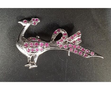 RUBY SET PEACOCK BROOCH in silver, approximately 4.7cm wide 