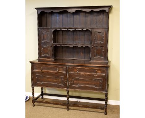 Early 20th Century oak high dresser in the late 17th Century taste, the upper stage having moulded cornice and shaped apron o