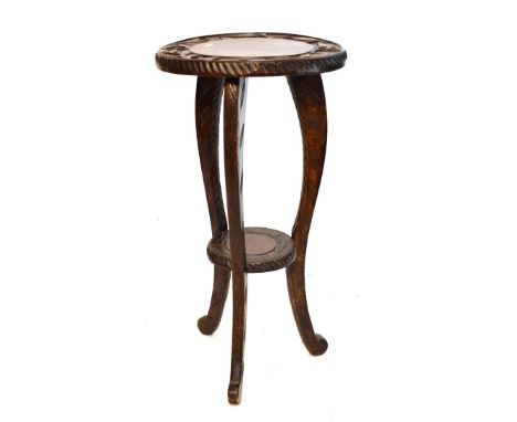 Early 20th Century carved plantstand, the circular top with stippled surround on three supports and under shelf   Condition: 