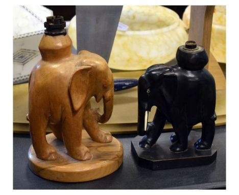 Two African carved wooden lamp bases, each modelled as a standing elephant   Condition: 