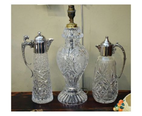 Two silver plated and cut glass claret jugs, together with a cut glass lamp base of baluster form (3)   Condition: 