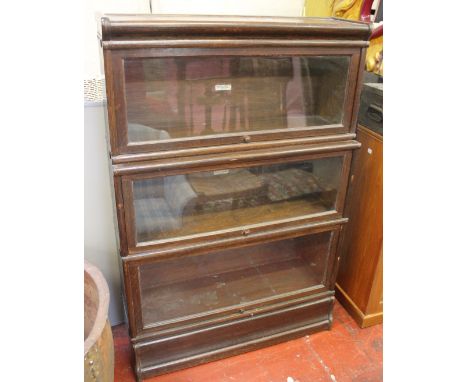A Globe Wernicke three section oak bookcase 129cm high, 87cm wide 