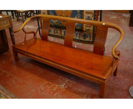 A Chinese hardwood bench with three decorated splats out swept arm supports on solid seat and square section legs 183cm lengt