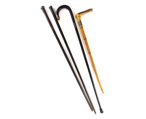 Four various sticks, including a riding crop with horn handle, two dandy canes and an ebonised walking stick. 