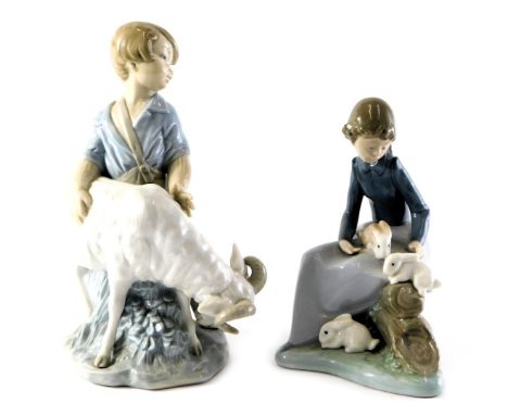 A Nao porcelain figure group, modelled as a young boy beside ram, printed marks, 20cm high, together with a young girl seated