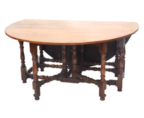 A 20thC yew gate leg dining table, in 17thC style, 160cm long x 175cm fully open. 