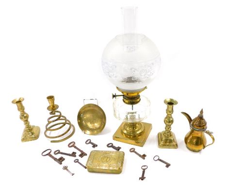 A Victorian oil lamp, with a part frosted shade, clear glass reservoir and a brass base (AF), a First World War chocolate tin