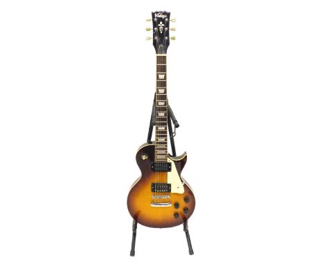 A Les Paul style electric guitar, stamped vintage, 102cm long, with a case and stand.&nbsp;