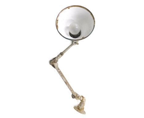 An industrial wall mounted adjustable lamp, with green enamel shade. (AF) 