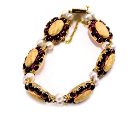 A Lucien Piccard Edwardian style bracelet, formed as oval sections set with cabochon rubies and two cultured pearl breaks, in