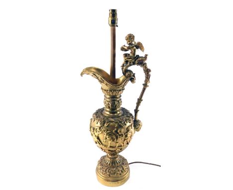 A late 19th/early 20thC Continental gilt metal table lamp, modelled in the form of a ewer decorated with putti, grapes, vines