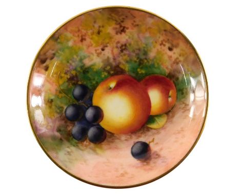 A Royal Worcester porcelain pin tray, decorated with fruit, signed Roberts, 9cm diameter.&nbsp;
