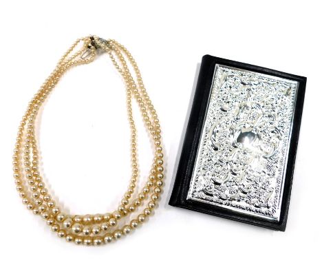 Two items, comprising a white metal fronted telephone book, stamped 925, and a Rosita of Warwick cultured pearl necklace, box