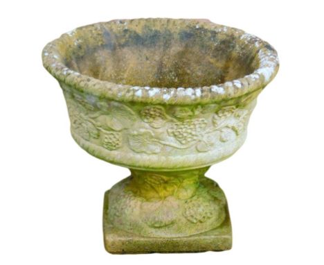 A sandstone circular planter, with lattice beaded border, above arrangement of leaves and vines, on a square set base, 30cm h