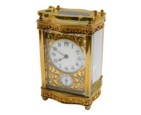 A late 19thC brass carriage clock, the circular enamel dial bearing Arabic numerals, subsidiary seconds, scroll spandrels, th