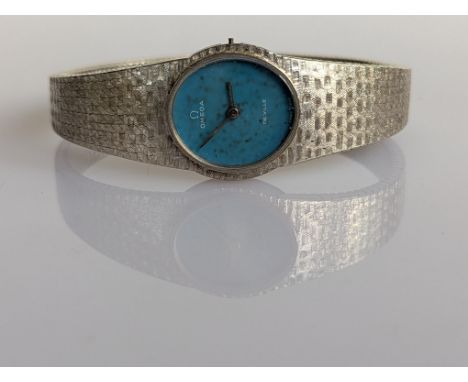 A vintage ladies Omega De Ville manual wristwatch with oval blue dial, white gold case and textured strap, deployment clasp, 