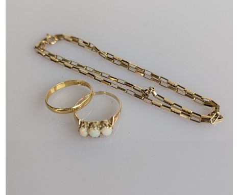 An 18ct yellow gold wedding band, 3mm, size O, 1.5g; a three-stone opal ring on a 14ct yellow gold setting, size P, 1.75g and