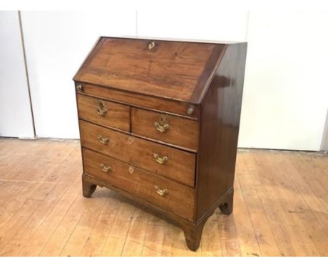 A George II Irish walnut bureau, c. 1750, the fall front enclosing a fitted interior with shaped drawers and compartments abo