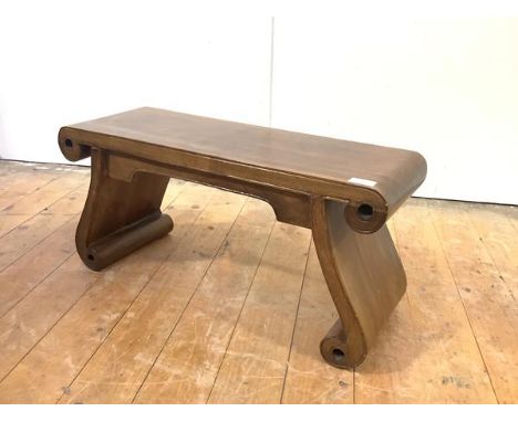 A narrow Chinese hardwood stool, the rectangular seat with incised lines and scroll terminals above a shaped frieze and downs