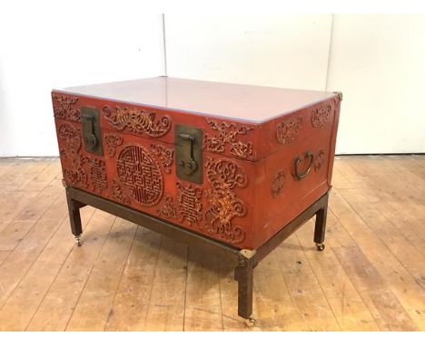 A Chinese red lacquered leather trunk, mid-20th century, the hinged top with later perspex cover, enclosing a leather-lined i