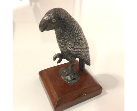 A 19th century white-metal model of a parrot, modelled with one claw upraised and fitted with glass eyes, bearing Registratio