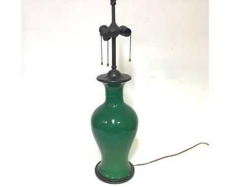 A large crackle glazed porcelain table lamp in the Chinese taste, of baluster form, green-glazed, with patinated metal base a