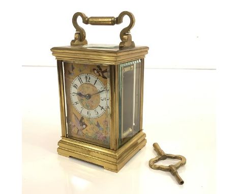A late 19th century French brass carriage clock, the gilt dial with white enamel chapter ring and decorated with birds, butte