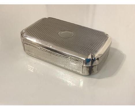 A George III silver snuff box, London 1811 (maker's mark indistinct), of rectangular form, with rounded corners and engine-tu