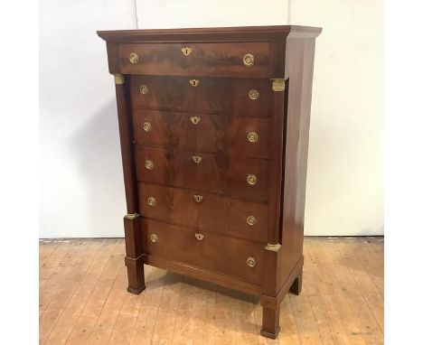 A French Empire Revival mahogany chest, c. 1900, of six graduated drawers, within turned columns and with engine-turned mount