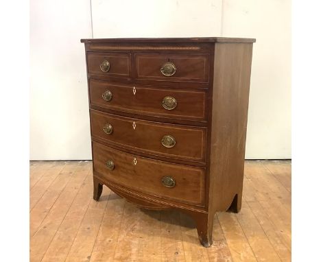 A Regency mahogany bowfront chest, c. 1810, probably Scottish, ebony lines and chequer banding, raised on bracket feet. 101cm