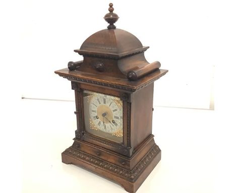 A 19th century German oak-cased mantel clock, with gilt-brass dial, the silvered chapter ring with Roman numerals, within a c