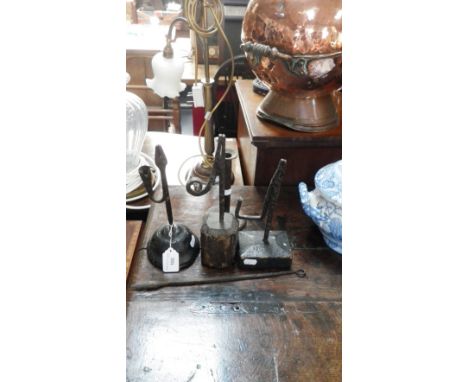 An 18th century iron rush lamp with oak base, inscribed "J.R." and others similar