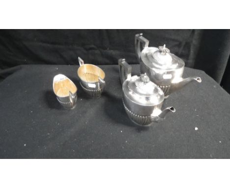 Walker & Hall, Sheffield: A silver four piece tea service, comprising a teapot, hot water pot, sucrier and milk jug, all with